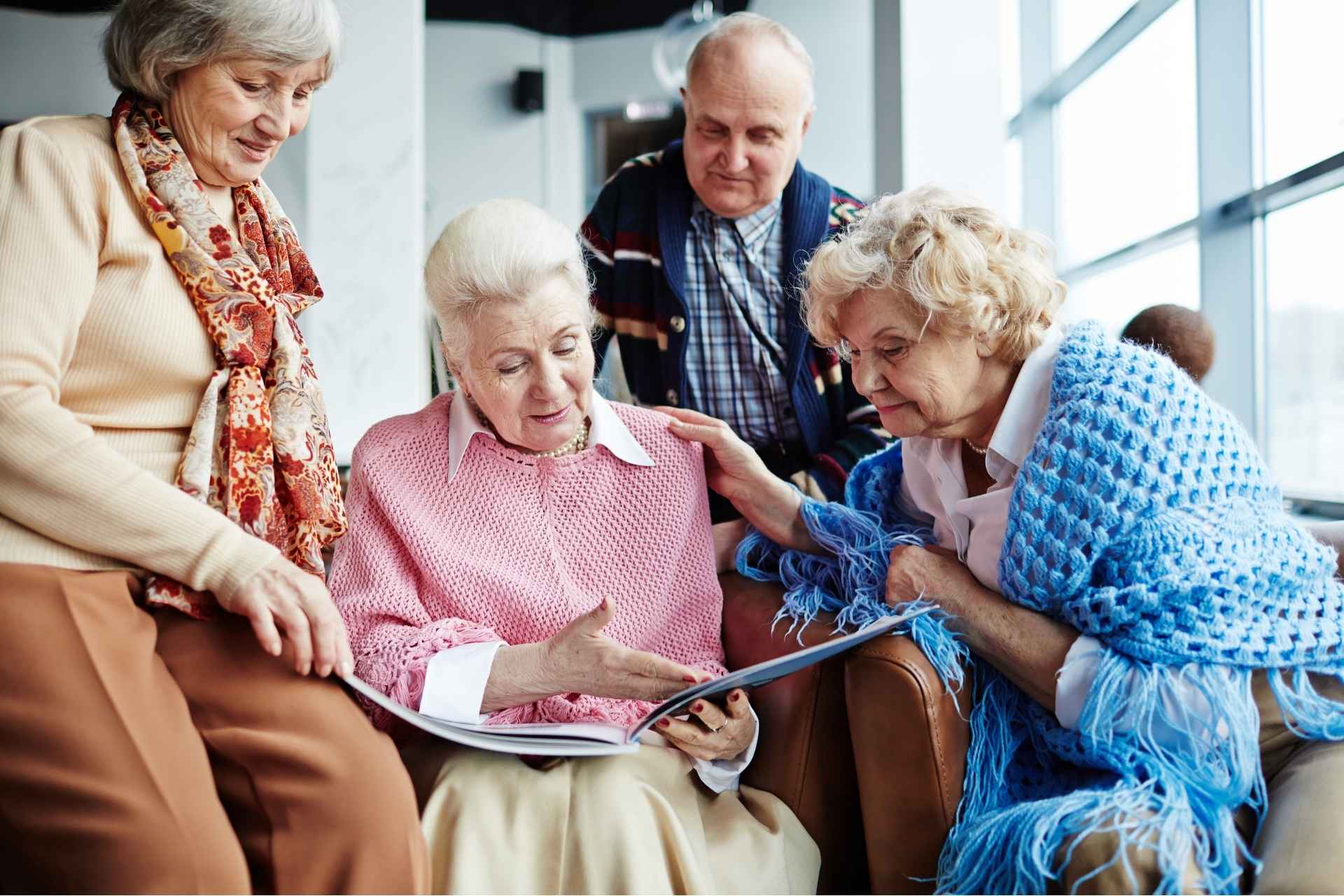 seniors looking over memory book together